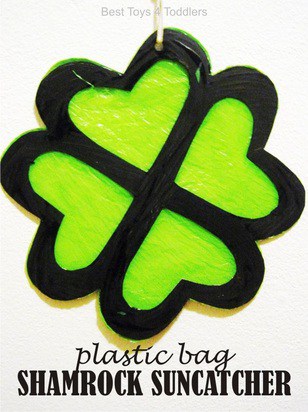 This shamrock suncatcher is made of plastic bags, tape, and is green.