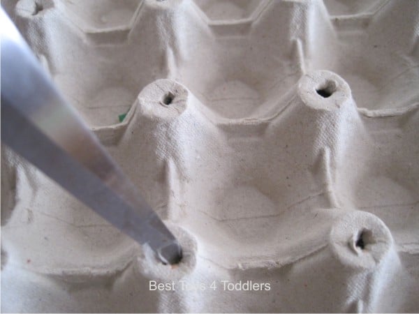 Easy way to practice fine motor skills with toddlers as they plant flowers in egg carton garden