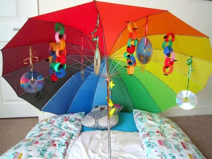 Laying down under the rainbow umbrella as a visual processing activity.